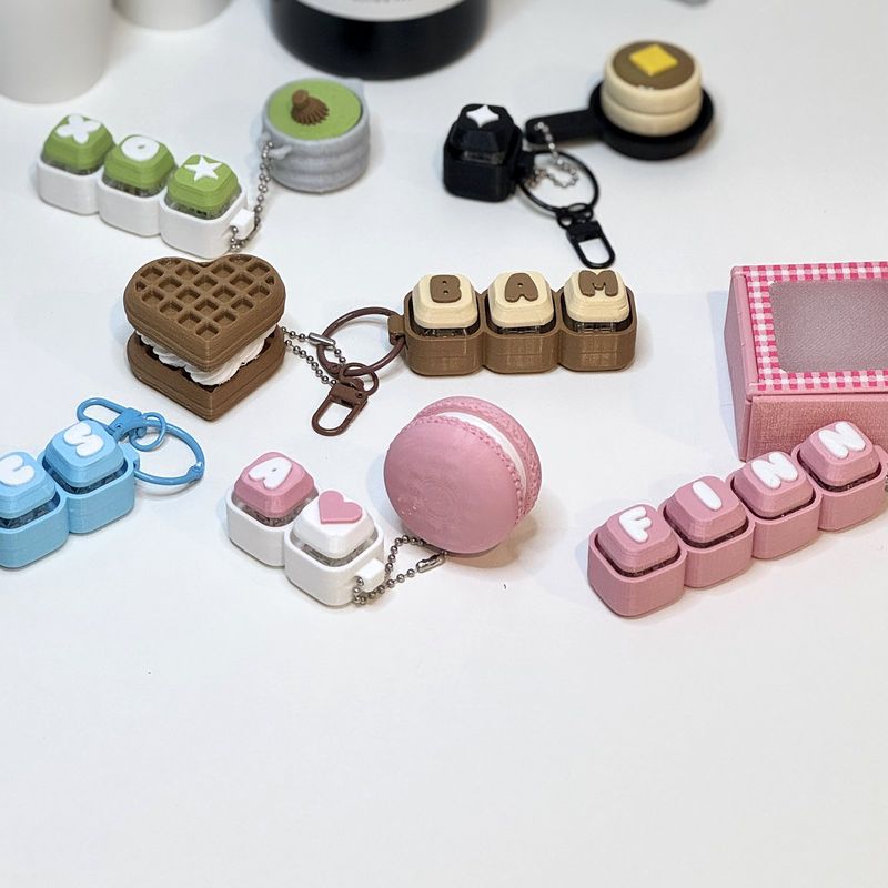 A desk scattered with keychains and a cake box