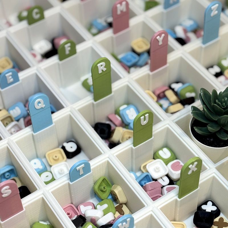 Trays of letter keycaps sorted A to Z