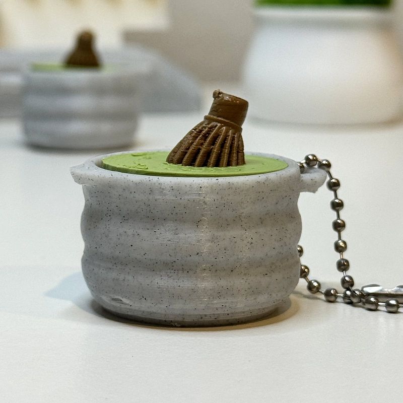 Matcha bowl keychain with a whisk on the lid